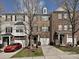 Traditional townhome showcasing multi-tone brickwork, attached garages, and bare trees enhancing its curb appeal at 14121 Winford Ln, Charlotte, NC 28262