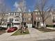 This townhome complex features a red car parked in front of one of the units at 14121 Winford Ln, Charlotte, NC 28262