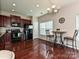 Bright kitchen with dark wood floors and cabinets, black appliances, a breakfast nook, and lots of natural light at 14121 Winford Ln, Charlotte, NC 28262