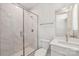 Modern bathroom featuring a glass-enclosed shower, white marble tiles, and a vanity at 15009 Brownleigh Ln # 26, Huntersville, NC 28078
