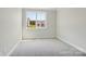 Cozy bedroom with neutral carpet, a large window, and plenty of natural light, creating a peaceful retreat at 15009 Brownleigh Ln # 26, Huntersville, NC 28078