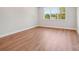 Light filled bedroom with hardwood floors and a large window, offering a serene space for relaxation at 15009 Brownleigh Ln # 26, Huntersville, NC 28078