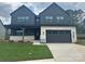 Beautiful two story home featuring a front porch, well-manicured lawn, and a two-car garage at 15009 Brownleigh Ln # 26, Huntersville, NC 28078