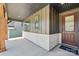Inviting front porch with stone accents and modern siding leading to the home's entryway at 15009 Brownleigh Ln # 26, Huntersville, NC 28078