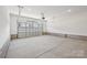 Bright garage showcasing an automatic door and large storage area and bright overhead lighting at 15009 Brownleigh Ln # 26, Huntersville, NC 28078