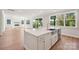 Open-concept kitchen island featuring white countertops, a stainless steel sink, and modern appliances at 15009 Brownleigh Ln # 26, Huntersville, NC 28078