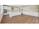 Beautiful bright kitchen with white cabinets, island, stainless steel appliances, and wood-look flooring at 15009 Brownleigh Ln # 26, Huntersville, NC 28078