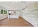 Bright and spacious modern kitchen with white cabinets, an island, and wood-look flooring at 15009 Brownleigh Ln # 26, Huntersville, NC 28078
