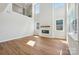 Bright and spacious living room features a modern fireplace, wood floors, and lots of natural light at 15009 Brownleigh Ln # 26, Huntersville, NC 28078