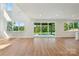 A bright, open-concept living room with a sliding door view to a covered patio and yard at 15009 Brownleigh Ln # 26, Huntersville, NC 28078