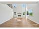 Bright and spacious living room features a modern fireplace, wood floors, and lots of natural light at 15009 Brownleigh Ln # 26, Huntersville, NC 28078