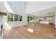 A light-filled living room featuring wood floors and an open-concept design that connects to the kitchen at 15009 Brownleigh Ln # 26, Huntersville, NC 28078