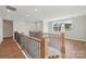 Upstairs loft with wooden banisters overlooks the neighborhood, providing a bright, open space at 15009 Brownleigh Ln # 26, Huntersville, NC 28078