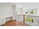 Upstairs loft area featuring a built-in desk and a view of the lawn and trees at 15009 Brownleigh Ln # 26, Huntersville, NC 28078
