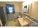 Bathroom with blue tile includes a shower/tub, toilet, and sink at 2427 Rhyneland St, Gastonia, NC 28054