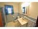 Bathroom with blue tile includes a shower/tub, toilet, and sink at 2427 Rhyneland St, Gastonia, NC 28054