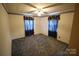 Empty bedroom features a ceiling fan, two windows, and neutral walls at 2427 Rhyneland St, Gastonia, NC 28054