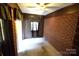 A cozy bedroom featuring a brick accent wall and a ceiling fan for added comfort at 2427 Rhyneland St, Gastonia, NC 28054