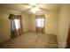Empty bedroom includes a ceiling fan, one window, and paneled walls at 2427 Rhyneland St, Gastonia, NC 28054