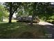 Quaint brick home with a well-manicured lawn, mature trees, and a serene residential location at 2427 Rhyneland St, Gastonia, NC 28054