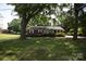 Attractive brick home with a lush green lawn and established trees, offering great curb appeal at 2427 Rhyneland St, Gastonia, NC 28054