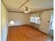 Inviting living room with hardwood floors, ceiling fan, and ample natural light, creating a cozy atmosphere at 2427 Rhyneland St, Gastonia, NC 28054
