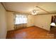 Comfortable living room with hardwood floors, a ceiling fan, and a traditional design, perfect for relaxation at 2427 Rhyneland St, Gastonia, NC 28054