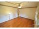 Bright living room with hardwood floors, a ceiling fan, and neutral decor, awaiting personal touches at 2427 Rhyneland St, Gastonia, NC 28054