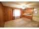 Cozy living room with wood paneling, carpet, and natural light, a canvas for personalized updates at 2427 Rhyneland St, Gastonia, NC 28054