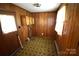 Room with paneled walls includes a door and built-in cabinets at 2427 Rhyneland St, Gastonia, NC 28054