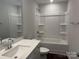 Clean bathroom with a shower over bath, white tiling, sink and toilet at 5540 Stafford Rd # 31, Charlotte, NC 28215