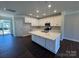 Bright kitchen with white cabinets, quartz countertops, stainless steel appliances, and hardwood floors at 5540 Stafford Rd # 31, Charlotte, NC 28215