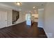 Spacious living area with an island kitchen, hardwood floors, stairs and a large window at 5540 Stafford Rd # 31, Charlotte, NC 28215
