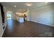 Open-concept living area with hardwood floors, recessed lighting, and a modern island kitchen at 5540 Stafford Rd # 31, Charlotte, NC 28215