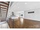 Bright living room with hardwood floors and modern staircase at 916-A Westbrook Dr, Charlotte, NC 28202