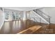 Sunlit living room featuring hardwood floors and staircase at 916-A Westbrook Dr, Charlotte, NC 28202
