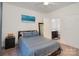 Comfortable bedroom with blue bedding and access to an ensuite bathroom with brown cabinets at 1000 E Woodlawn Rd # 415, Charlotte, NC 28209