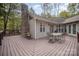 Spacious back deck with stone fireplace and seating area, perfect for outdoor entertaining at 15450 Millview Trace Ln, Mint Hill, NC 28227