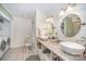 Bright bathroom with a double sink vanity, modern fixtures, and tiled floors at 15450 Millview Trace Ln, Mint Hill, NC 28227