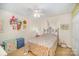 Bedroom with a floral bedspread and decorative wall hangings at 15450 Millview Trace Ln, Mint Hill, NC 28227