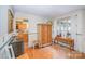 Elegant dining area with hardwood floors and adjacent view of the kitchen at 15450 Millview Trace Ln, Mint Hill, NC 28227