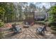 Relaxing fire pit area with stone patio and comfortable seating at 15450 Millview Trace Ln, Mint Hill, NC 28227