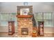 Stone fireplace with a wood mantle and decorative accents at 15450 Millview Trace Ln, Mint Hill, NC 28227