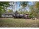 Ranch-style home with large deck and surrounding wooded area at 15450 Millview Trace Ln, Mint Hill, NC 28227