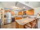 Well-lit kitchen with stainless steel appliances and breakfast bar seating at 15450 Millview Trace Ln, Mint Hill, NC 28227