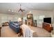 Inviting living room featuring a stone fireplace, vaulted ceiling, and ample natural light, perfect for relaxing and entertaining at 15450 Millview Trace Ln, Mint Hill, NC 28227