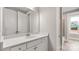 Bright bathroom featuring a white vanity with a white countertop and modern fixtures at 4440 Moxie Way, Charlotte, NC 28215