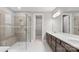 Modern bathroom features a tiled shower with a built-in bench, double vanity, and a walk-in closet at 4440 Moxie Way, Charlotte, NC 28215