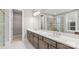 Stylish bathroom boasts double sinks, ample counter space, and a glass-enclosed shower with sleek fixtures at 4440 Moxie Way, Charlotte, NC 28215