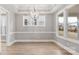 Bright dining room with large windows, modern chandelier, and stylish trim at 4440 Moxie Way, Charlotte, NC 28215
